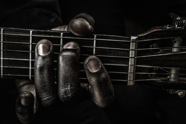 Close-up photo of hand playing guitar