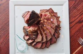 Slices of a dry-aged porterhouse topped with flaky salt at Stage Left Steak in New Brunswick.