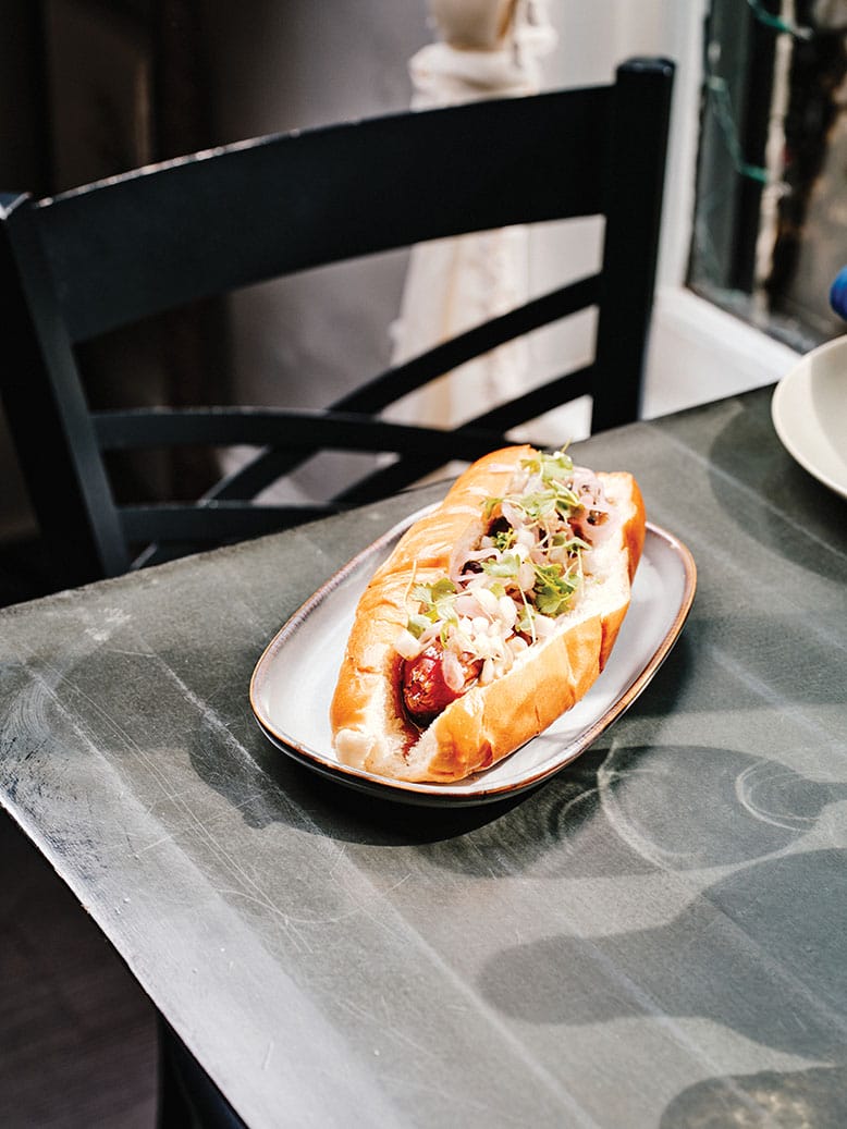 A Wagyu hot dog served with sweet-heat mustard, pickled shallot and celery on a brown-butter brioche bun, at Gass & Main in Haddonfield