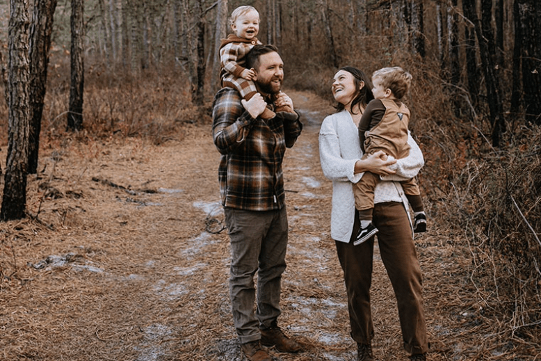 Danny and Katie Childs in the woods with their children