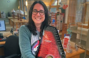 woman in library holding autoharp