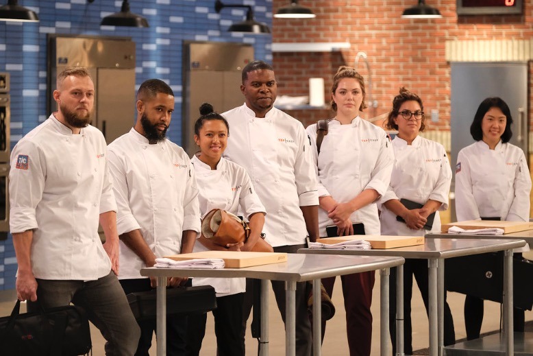 Leia Gaccione poses with six other competing chefs.