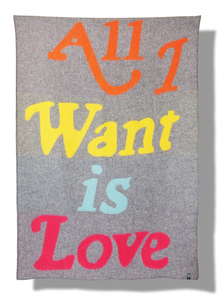 A gray wool blanket emblazoned with large, colorful text that reads, 