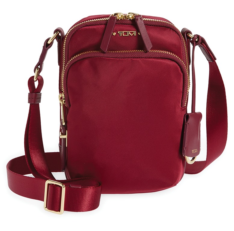 A red crossbody bag with gold hardware.