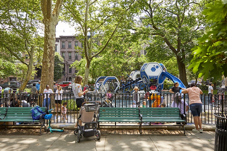 Families hang at a new brightly colored playground at Jersey City's Van Vorst Park