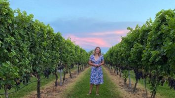Victoria Reader, founder of New Jersey Women in Wine, stands in a Salem County vineyard at sunset