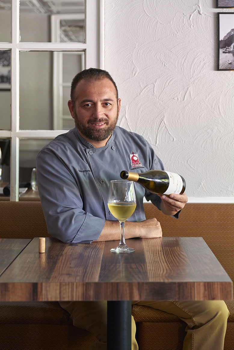 Vidalia chef/owner Salvatore Scarlata pours himself a glass of white wine