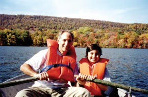 Ken Schlager on a boat with his young son.