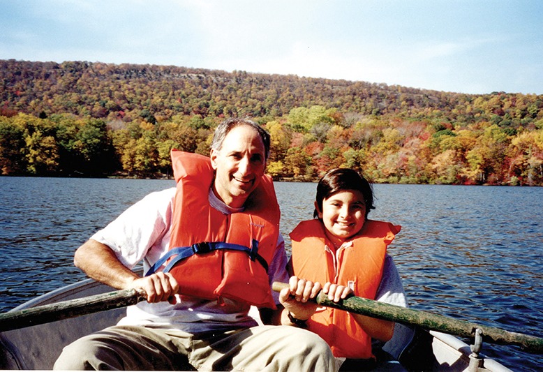 Ken Schlager on a boat with his young son.