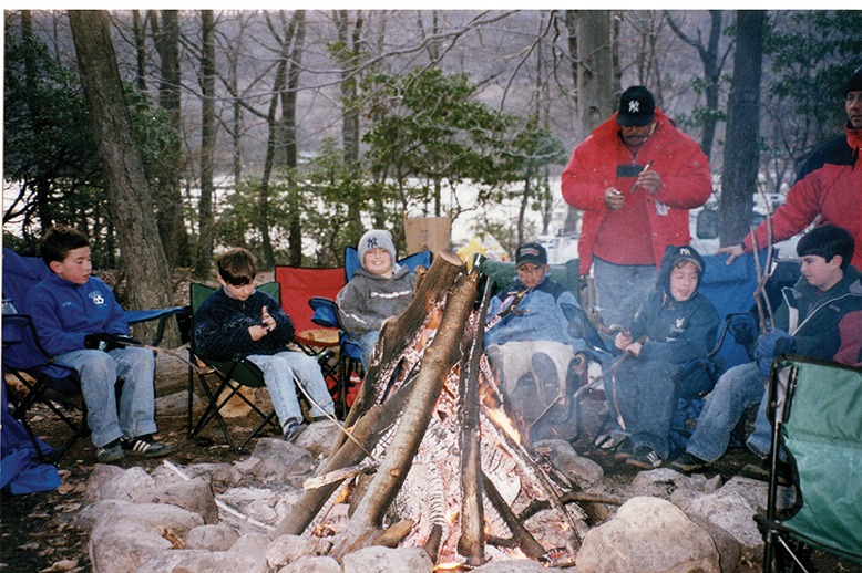 Fathers and sons around a campfire in the Catskills.