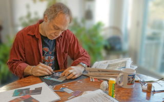 Peter Jacobs hard at work on a collage.