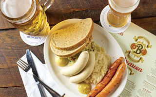 A plate of plump weisswurst, sauerkraut and frankfurters.