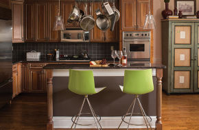 In the kitchen, a pot rack frees up valuable cabinet space. The green stools add a pop of color.