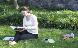 A resident reads on the Morristown Green.