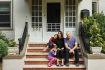Anat Soudry and Josh Scheier on the front stoop of their historic Montclair home with daughters Lia and Alma. The windows of the entry vestibule, behind them, are original to the 1912 structure.
