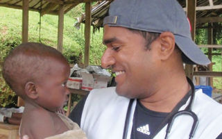 Nurse Saman Perera comforts a toddler in Congo.
