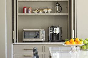 The breakfast bar, outfitted with LED lighting and electrical outlets, is concealed behind pocket doors.