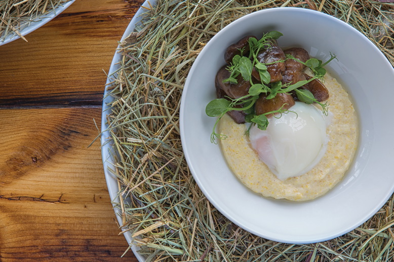 The Egg in a Nest combines a slow-cooked Double Brook Farm egg with chedder polenta, pea tendrils and mushrooms in a wreath of hay from the farm.