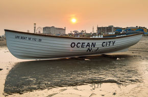 An Ocean City lifeguard surfboat at sunset.
