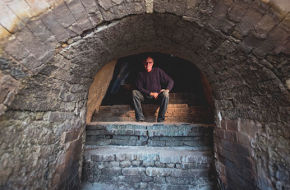Bruce Dehnert, head of ceramics at Peters Valley, sits inside the craft school's 46-foot-long Anagama kiln.