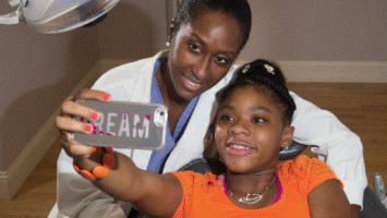 Karen Hankerson, 13, takes a selfie with Dr. Nicole McGrath at her private practice in Montclair. Photo by Andy Foster