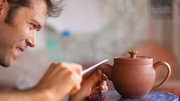 Jono Pandolfi, in his Union City studio, crafts stoneware teapots, plates and bowls for fine restaurants.