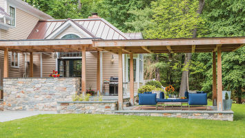 Susannah and Michael Sung's two-tiered patio provides not only shade, but energy savings. The lower-level patio, in a contemporary palette of blue and charcoal, is the hangout space. The structure's frame is made of insect-resistant Western red cedar.