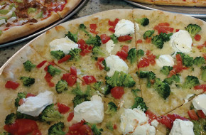 A specialty white pie with chopped broccoli, tomatoes and ricotta.