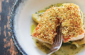 Olive-crusted salmon in a delicious herbaceous broth.