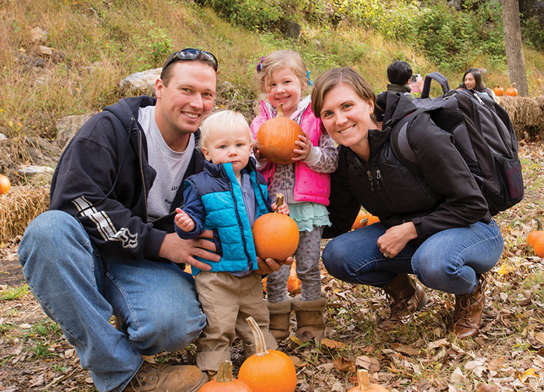 Picking out a free pumpkin is part of the experience, as demonstrated by passengers Jeff and Amy Hawrylo of Milford with their children Gavin and Paige. 