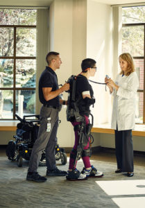 Laura Yurek lost the use of her legs and right arm as a result of a brain bleed last winter. She is trying to walk again at Kessler Institute in West Orange with the help of a robotic exoskeleton called Ekso Bionics GT.