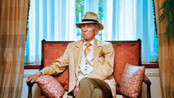 In his Manhattan apartment, Gay Talese relaxes in one of his customary sartorially splendid outfits.