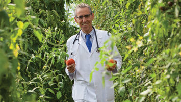 Dr. Ron Weiss grows tomatoes and other produce free of synthetic chemicals at Ethos Primary Care. He sees a whole-foods, plant-based diet as essential to improved health.