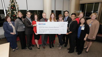 AtlantiCare Young Professionals present $5,000 check.