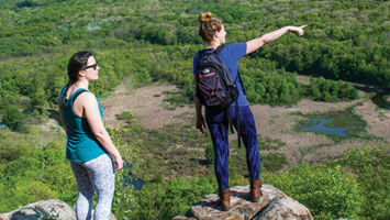 Reporter Joanna Buffum, right, points west toward Hackettstown from the heights of the Highland Trail through Allamuchy State Park.