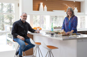 Fran and Richard in their renovated kitchen. The couple kept the layout but upgraded all the materials. The shelf nook above the window is original.