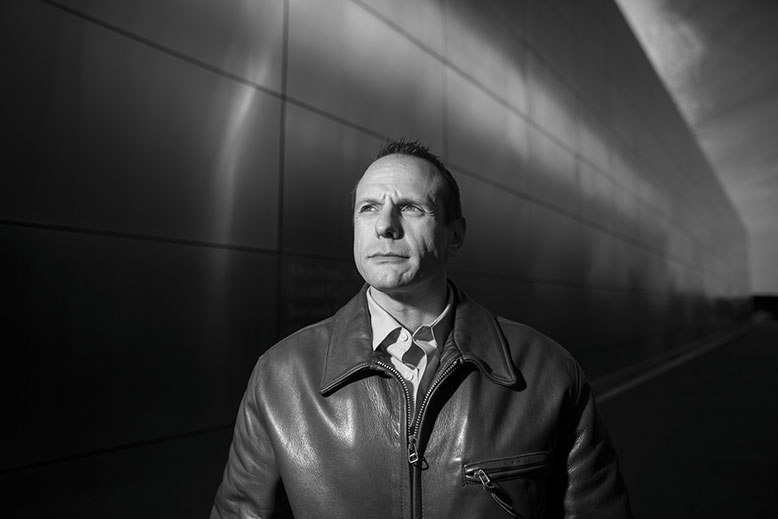 After his release from prison, John Koufos (seen here in Liberty State Park at the Empty Sky memorial to New Jersey’s 9/11 victims) often wandered around Jersey City pondering his future. He found meaningful work at the nonprofit New Jersey Reentry Corporation helping other ex-prisoners.