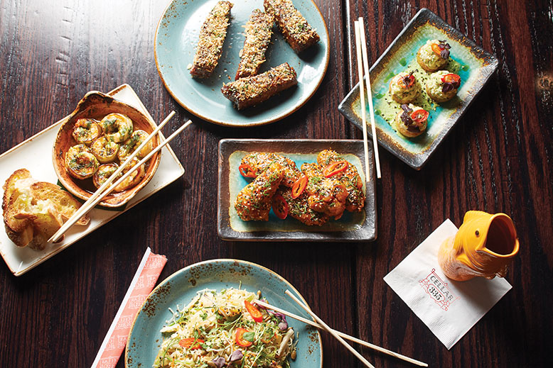 Clockwise from top: Crispy duroc ribs, hamachi tartare, Korean-style wings, tropical salad, shrimp and garlic.