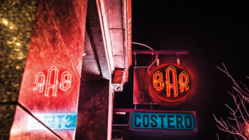 The exterior signage of Barrio Costero in Asbury Park at night.