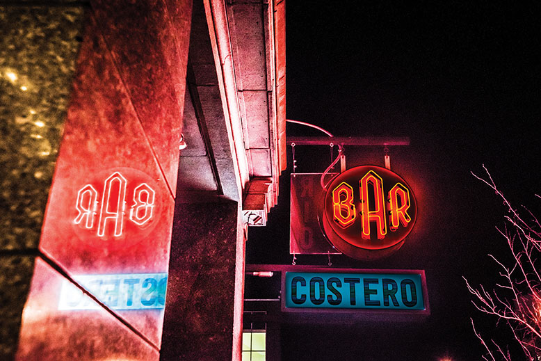 The exterior signage of Barrio Costero in Asbury Park at night.