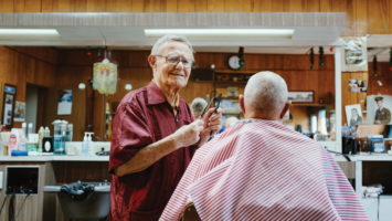Joe Barca opened his Elmer barbershop in 1952. Now approaching age 100, he still caters to customers like Stephen Garrison, a longtime regular.