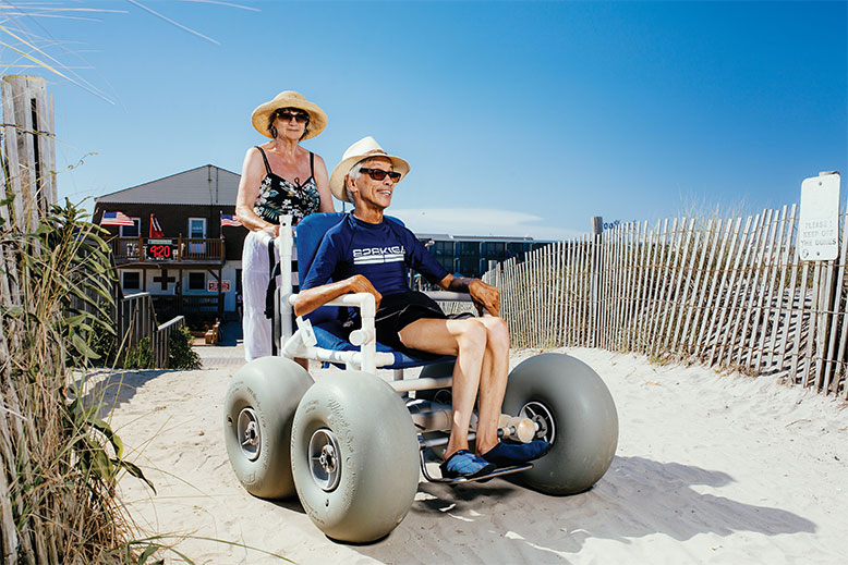 Ed Titterton enjoys summer days on the sand in North Wildwood, thanks to a town-supplied surf chair and the help of his wife, Sue.