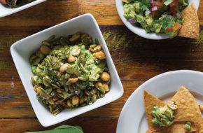 Three guacamoles, clockwise from top left, with bacon and brussel sprouts, traditional, and with peanuts and pumpkin seeds.