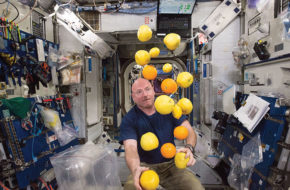 A playful Scott Kelly displays his formidable juggling skills in the weightless environment aboard the International Space Station.