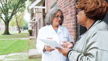 Nurse practitioner Darcel Reyes, left, confers with community health worker Barbara Robinson at Stephen Crane Village, an affordable housing community in Newark.