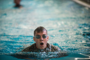 The trainees must swim four lengths of the pool in under four minutes with their fatigues on.