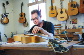 Ian Kelly at work in his Little Falls guitar retail and repair shop. Kelly counts Pink Floyd’s Roger Waters among his loyal clients.