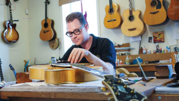 Ian Kelly at work in his Little Falls guitar retail and repair shop. Kelly counts Pink Floyd’s Roger Waters among his loyal clients.