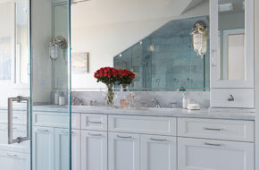 Passanante chose stainless fixtures and hardware to add a touch of sparkle to the room. The custom mirror reflects the entire space, making the room appear larger than it is.