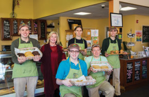 Karen Monroy with members of the Grateful Bites team, from left, Zack, Nate, Eric, Mike and Harry. The bakery is staffed by young adults with developmental disabilities.